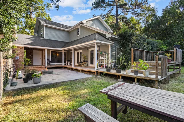 a view of a house with pool and chairs in patio