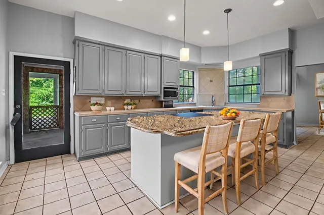 a kitchen with a sink a window and cabinets