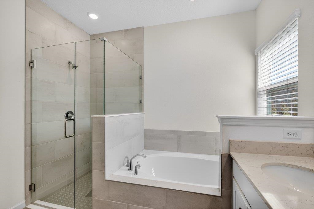 210 White Rabbit Run St. Augustine, FL 32092 - Photo 51 of 85 a bathroom with a tub a sink and a shower