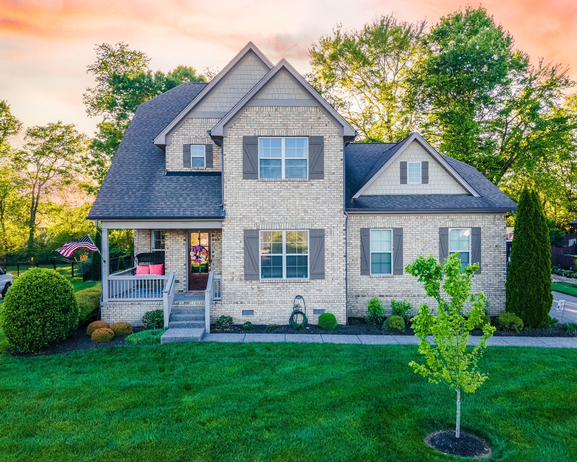 a front view of a house with garden and porch