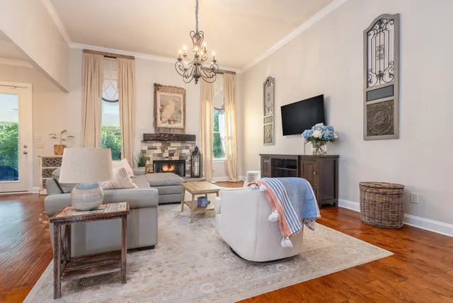 a living room with furniture a fireplace and a flat screen tv