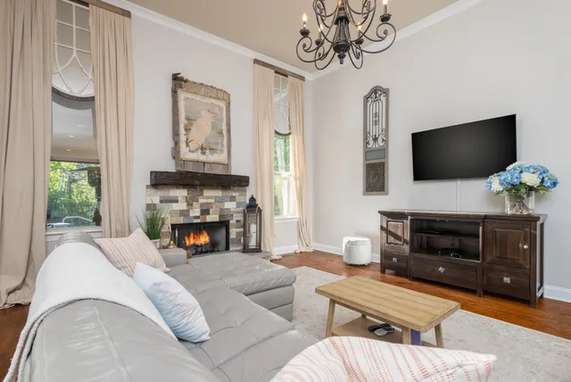a living room with furniture or couch and a chandelier