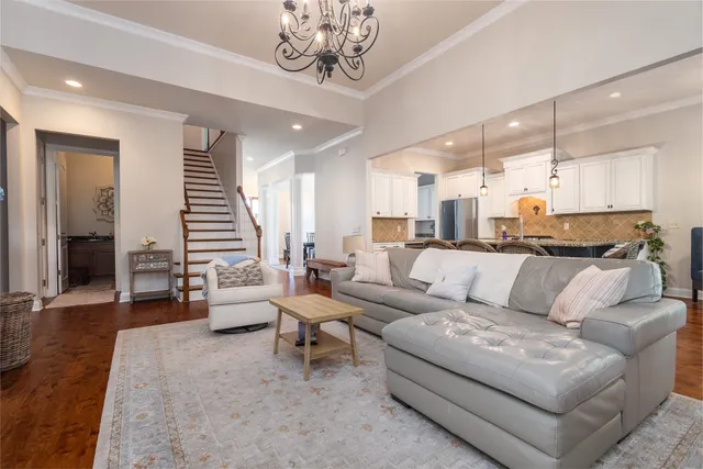 a kitchen with kitchen island a dining table chairs sink and cabinets