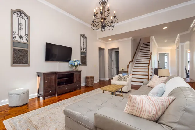 a kitchen with stainless steel appliances granite countertop a sink a stove a refrigerator and island with wooden floor