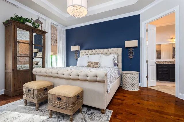 a bathroom with a granite countertop bathtub a double vanity sink and a mirror