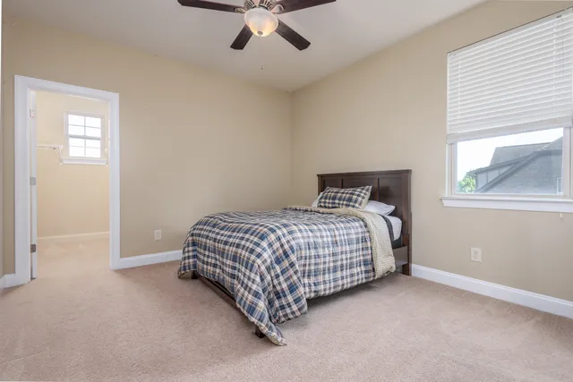 a spacious bedroom with a bed and a dresser