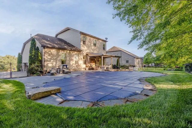 an aerial view of a house with swimming pool and garden view