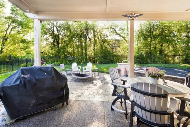 a view of a house with backyard and sitting area