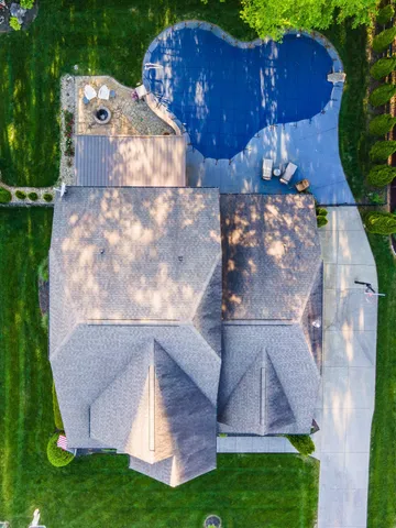 a view of a chairs and table in backyard of the house