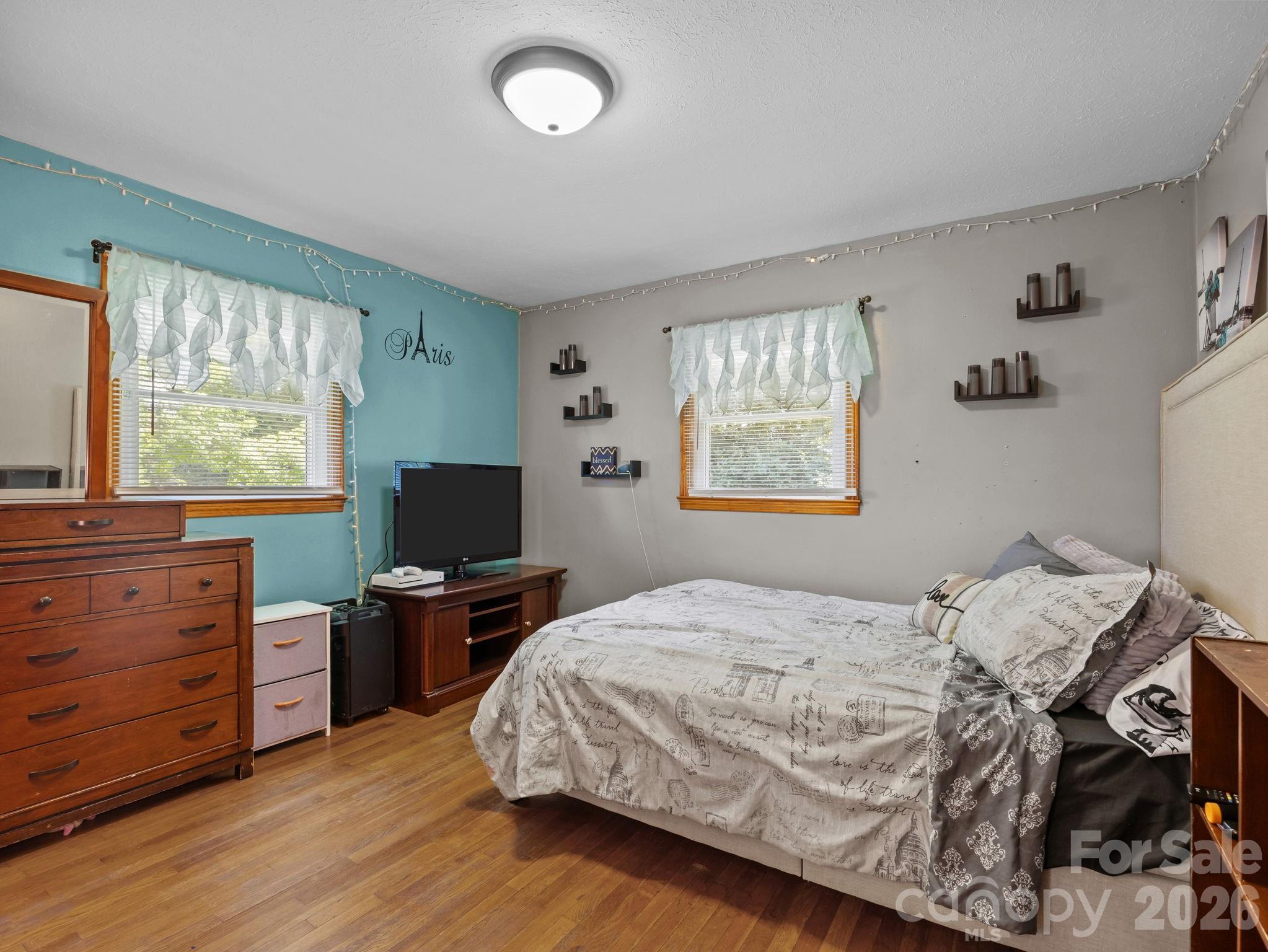 50 Baldwin Road Arden, NC 28704 - Photo 19 of 24 a bedroom with a bed and a flat screen tv