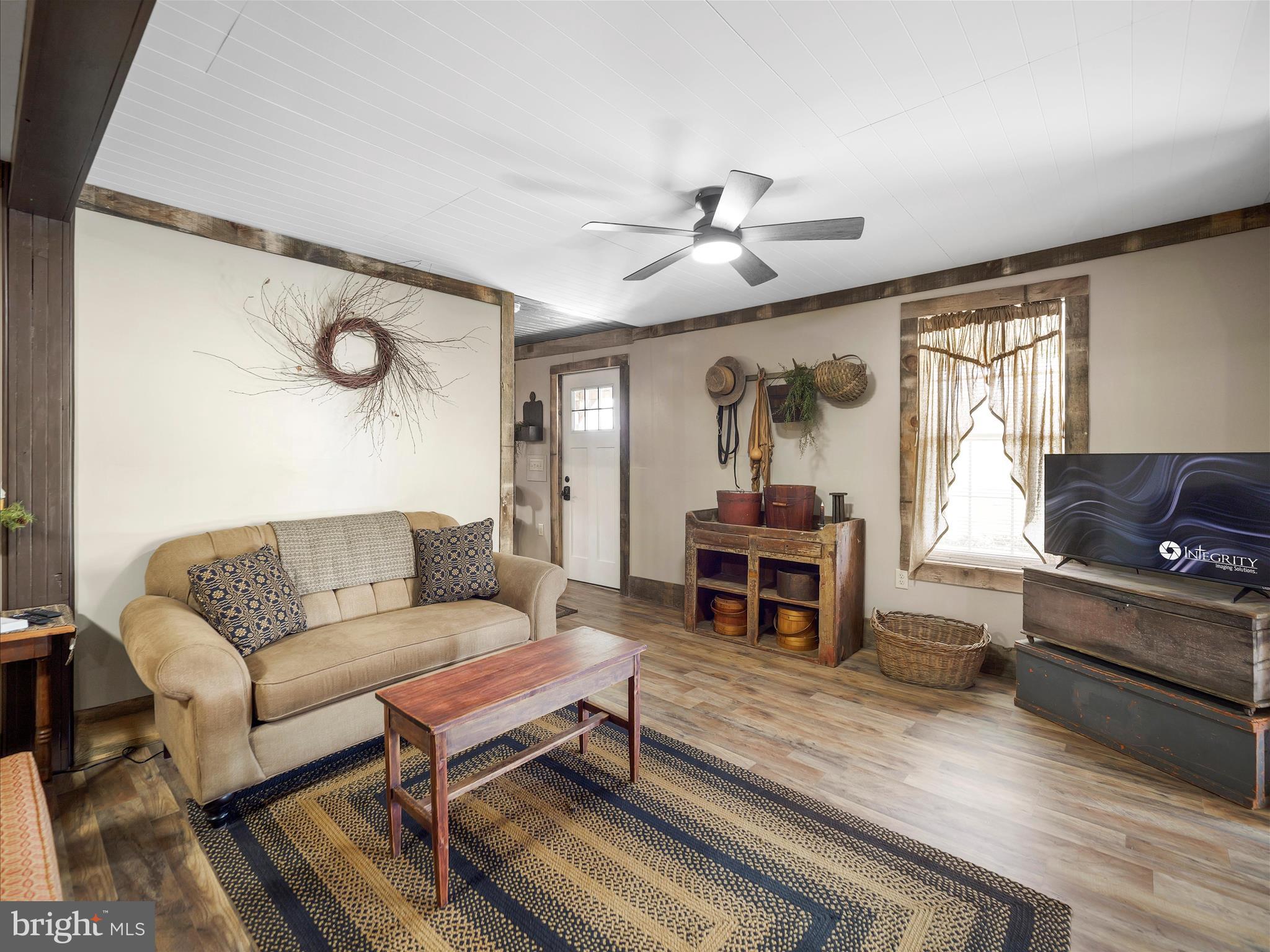 19031 Back Road Dry Run, PA 17220 - Photo 12 of 46 a living room with furniture a wooden floor and a piano
