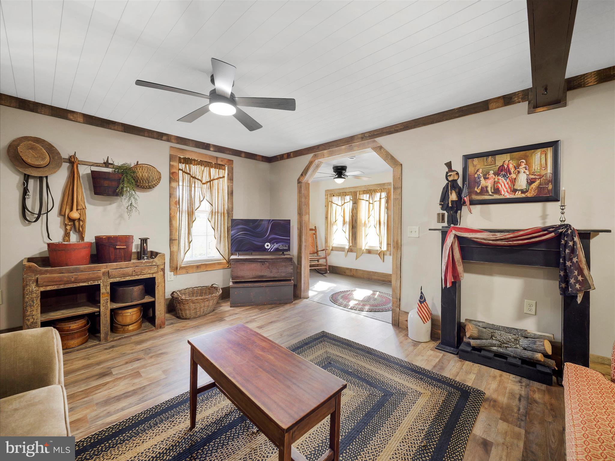 19031 Back Road Dry Run, PA 17220 - Photo 14 of 46 a living room with furniture a flat screen tv and kitchen view