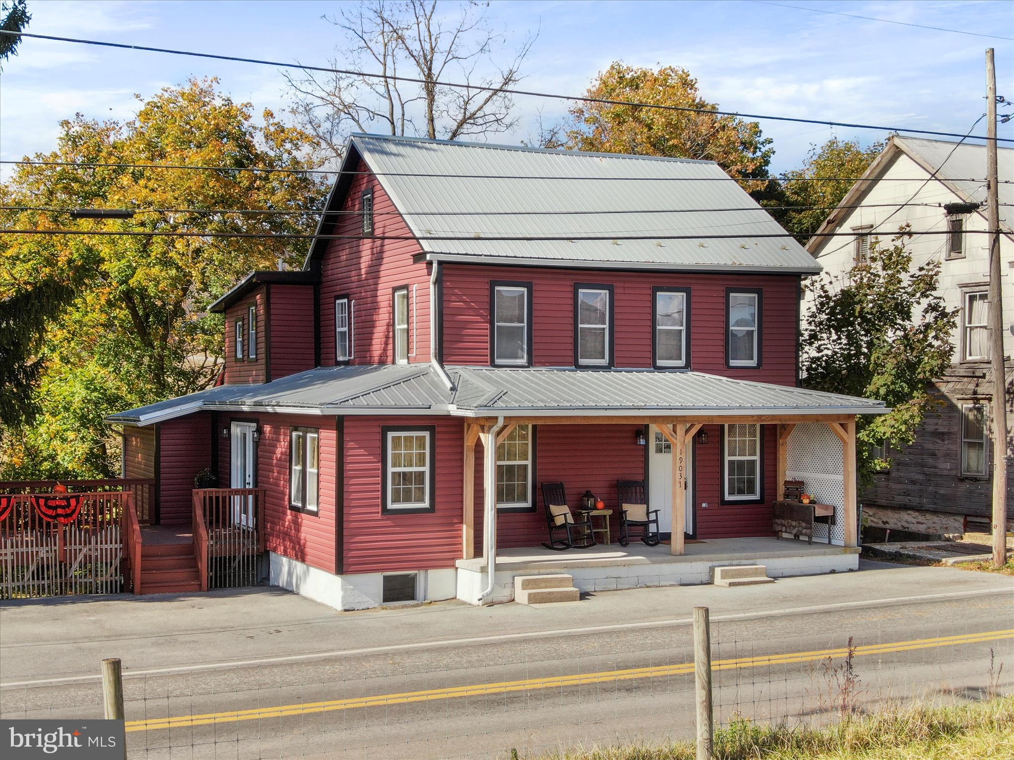 19031 Back Road Dry Run, PA 17220 - Photo 2 of 46 a view of a white house with large windows and a table and chairs