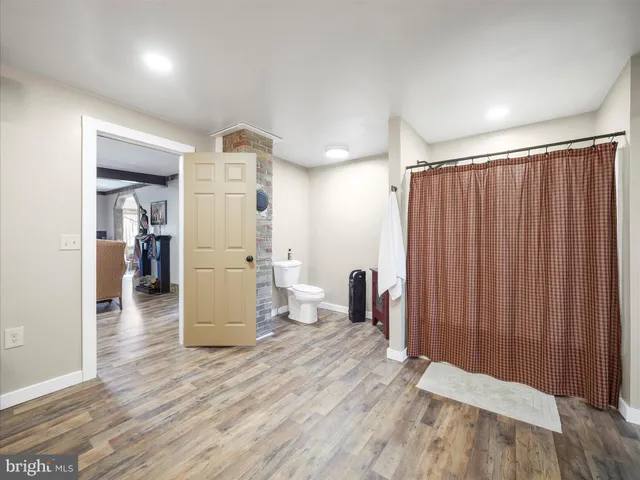 wooden floor in an empty room with a kitchen