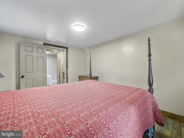 a bed room with a bed and a mirror