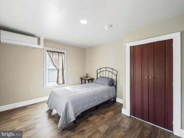 a bedroom with a bed and window