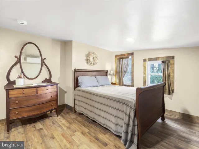 a bed room with a bed and a painting on the wall