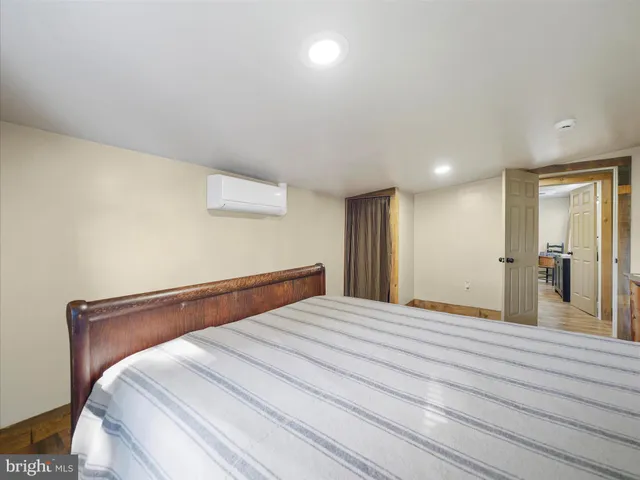 a bedroom with a bed and a large mirror