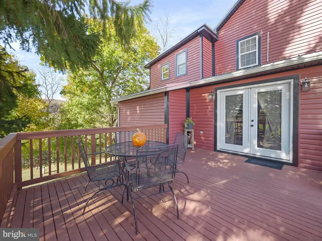 a view of a chair and table on the wooden deck