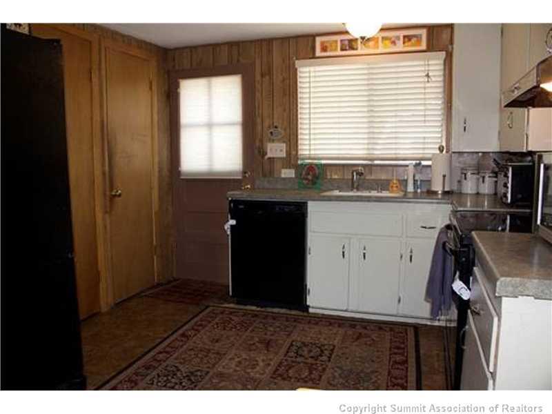 32 J Road Silverthorne, CO 80498 - Photo 8 of 16 a kitchen with a sink a window and cabinets