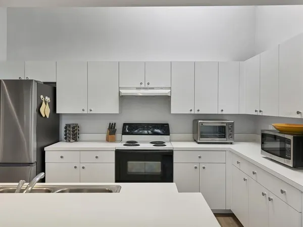 a kitchen with cabinets appliances and sink