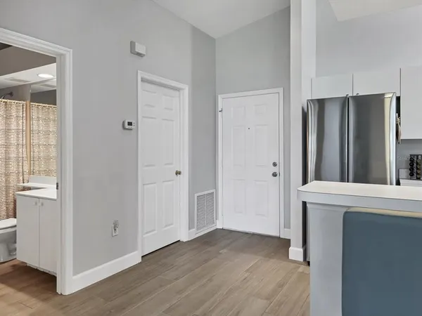 a bedroom with a bed and a night stand