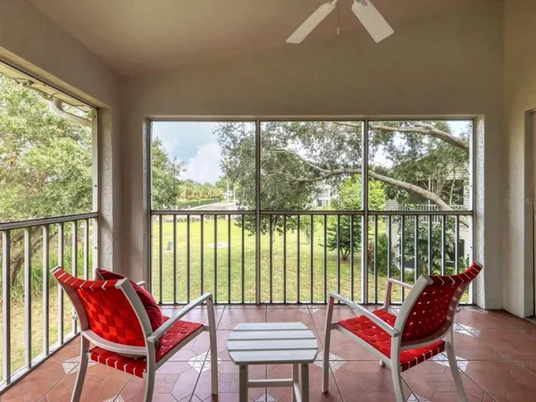 a living room with furniture and a floor to ceiling window