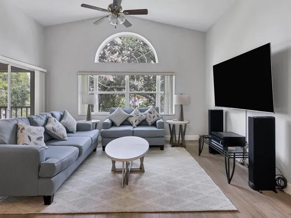 a living room with furniture a rug and a flat screen tv