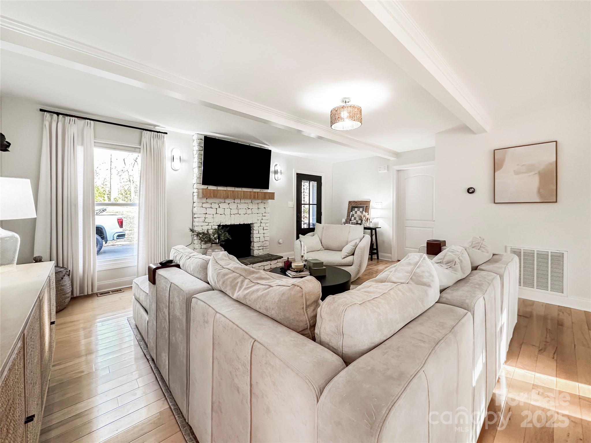 9501 Bartlett Road Mint Hill, NC 28227 - Photo 17 of 48 a living room with furniture a flat screen tv and a fireplace