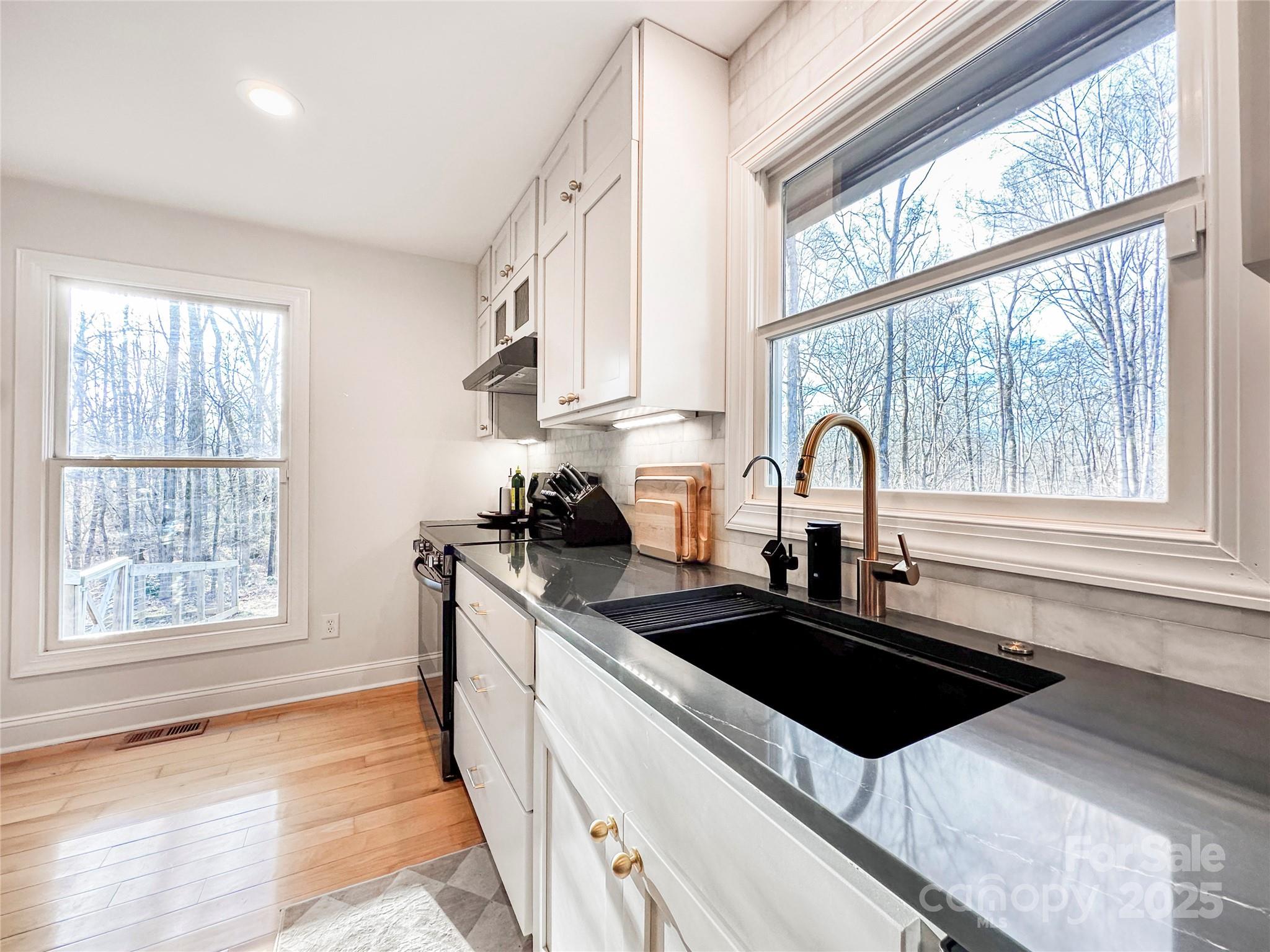 9501 Bartlett Road Mint Hill, NC 28227 - Photo 24 of 48 a kitchen with stainless steel appliances a sink a stove a counter space and a window