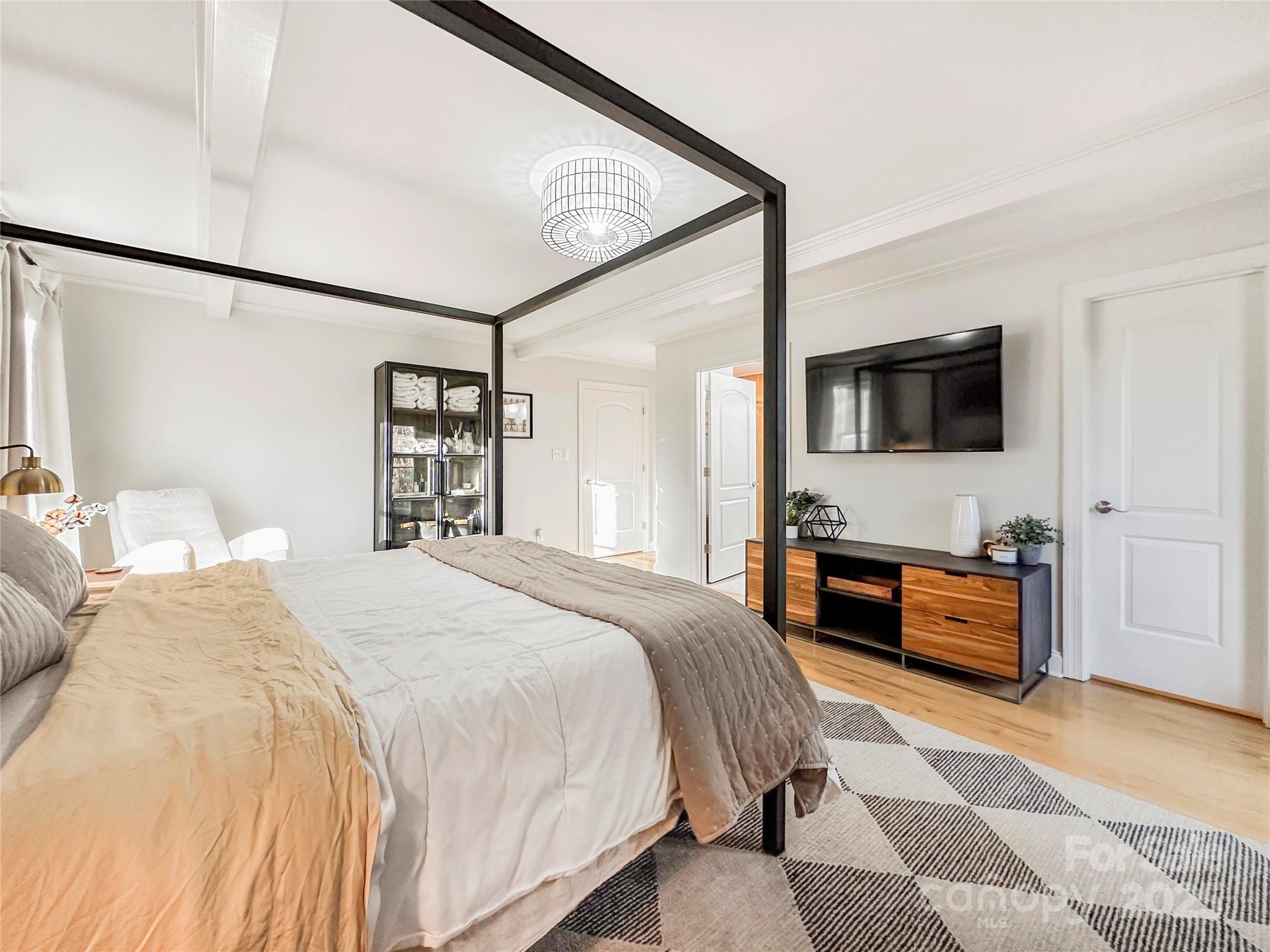 9501 Bartlett Road Mint Hill, NC 28227 - Photo 29 of 48 a bedroom with a bed and dresser with mirror
