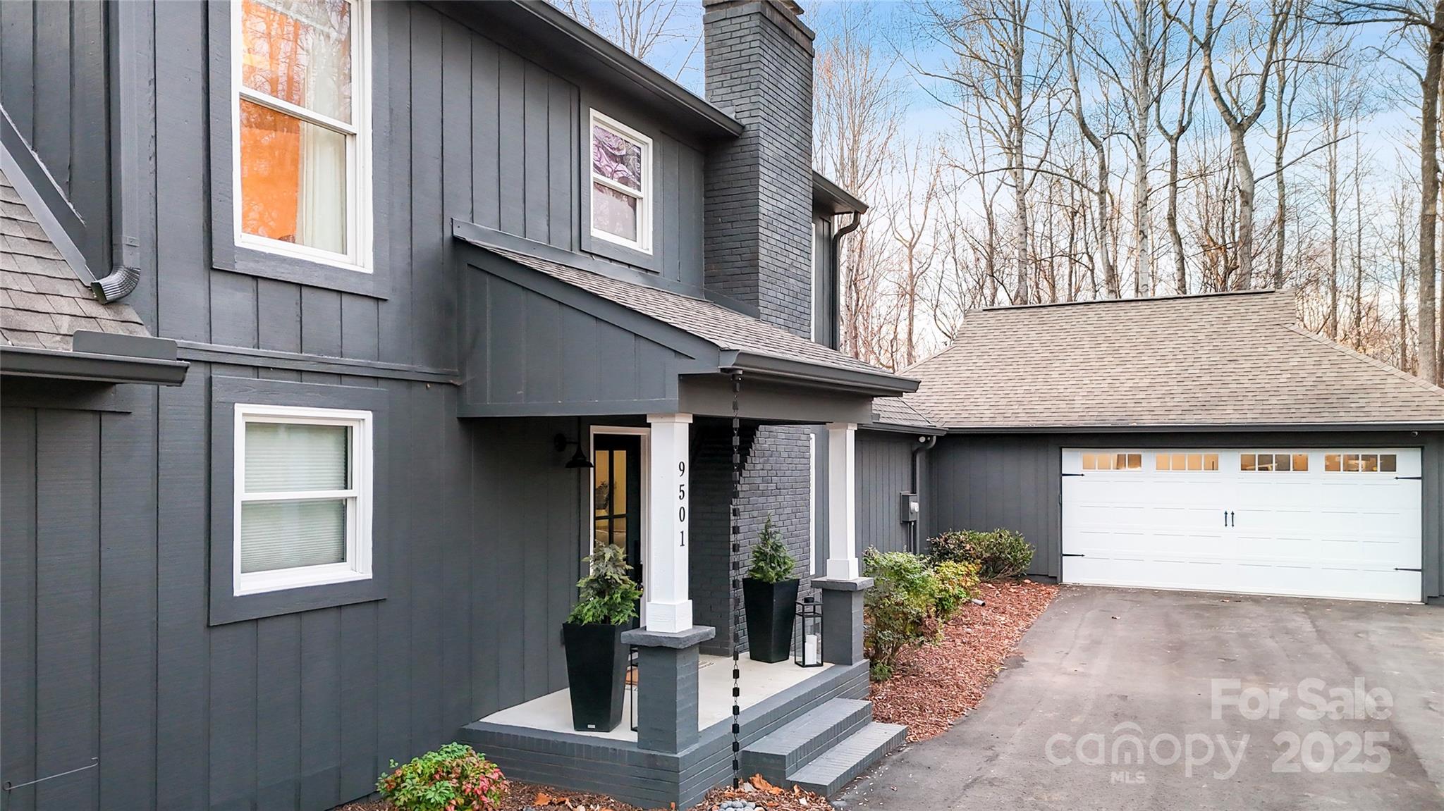 9501 Bartlett Road Mint Hill, NC 28227 - Photo 10 of 48 a view of a house with potted plants and a table and chairs
