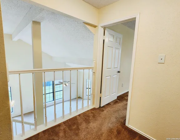 a view of a hallway with wooden floor and entryway
