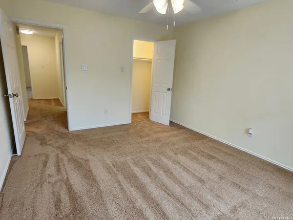 an empty room with windows and closet