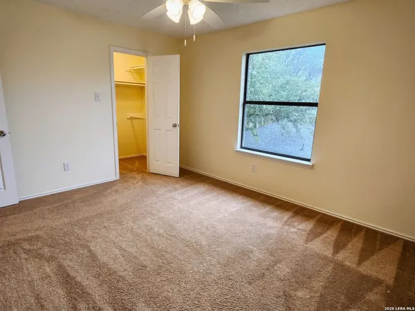 a bathroom with a granite countertop sink a toilet and a large mirror