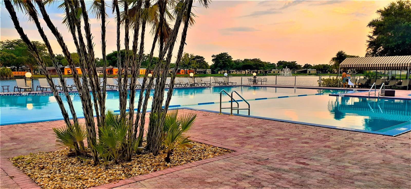 250 Gate Road, Unit 160 Hollywood, FL 33024 - Photo 1 of 33 a view of a swimming pool with a patio and a garden