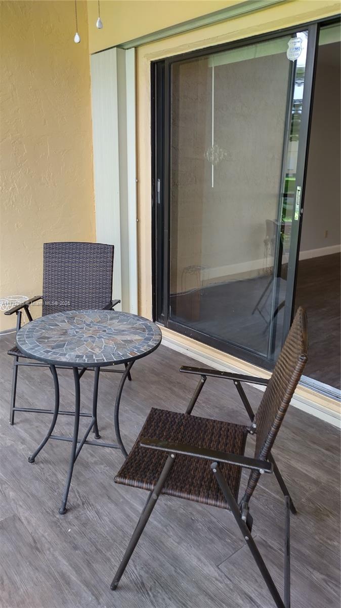250 Gate Road, Unit 160 Hollywood, FL 33024 - Photo 16 of 33 a workspace with wooden floor and glass door