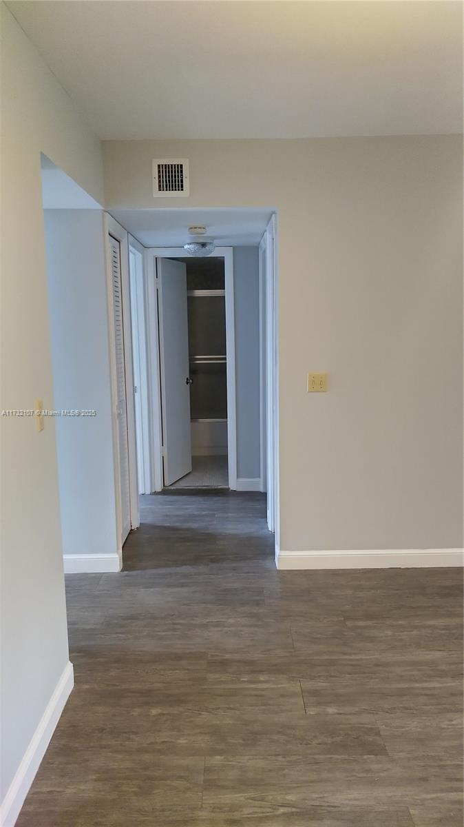 250 Gate Road, Unit 160 Hollywood, FL 33024 - Photo 27 of 33 a view of an empty room with wooden floor and a window