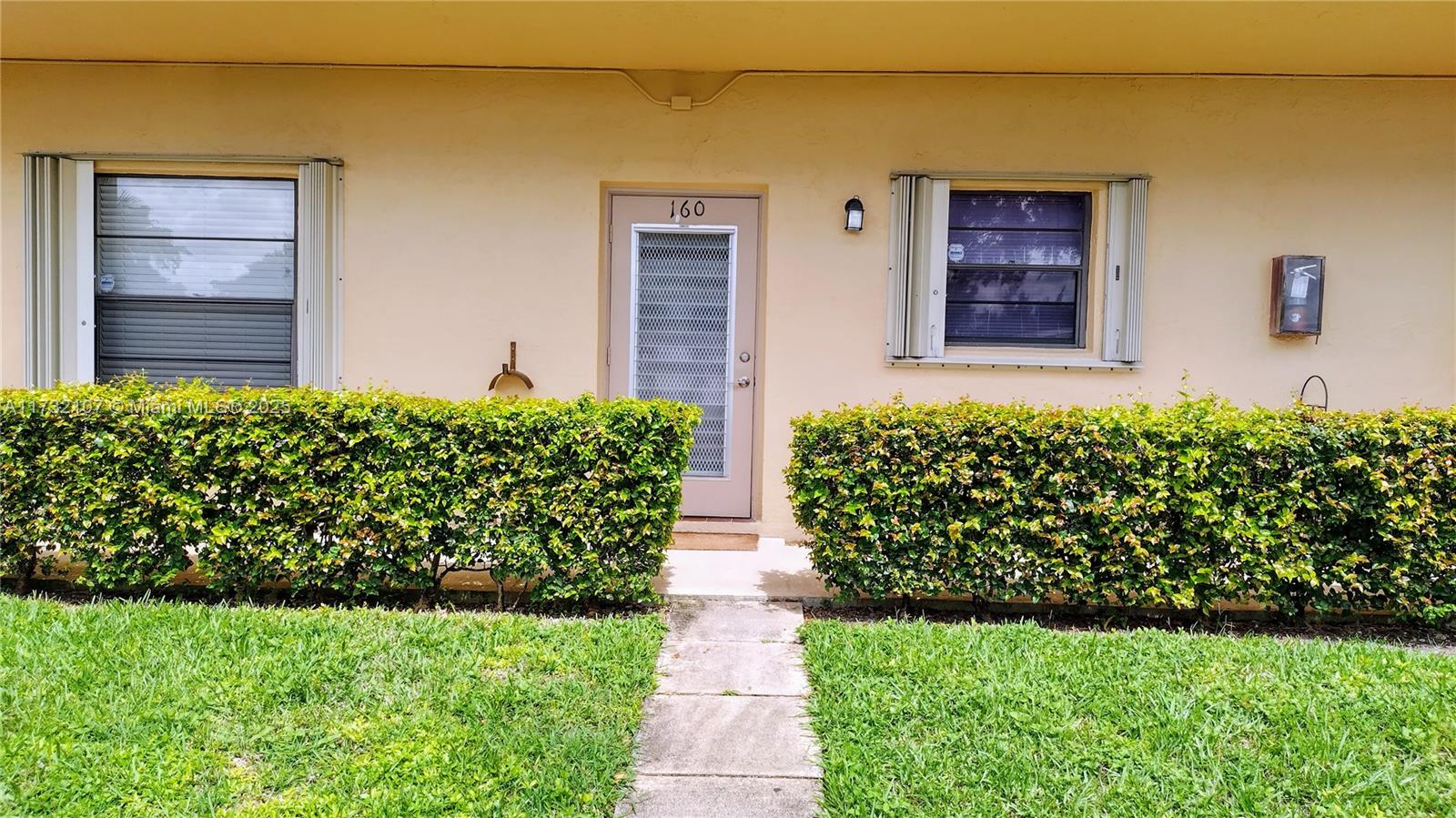 250 Gate Road, Unit 160 Hollywood, FL 33024 - Photo 28 of 33 front view of a house with a yard