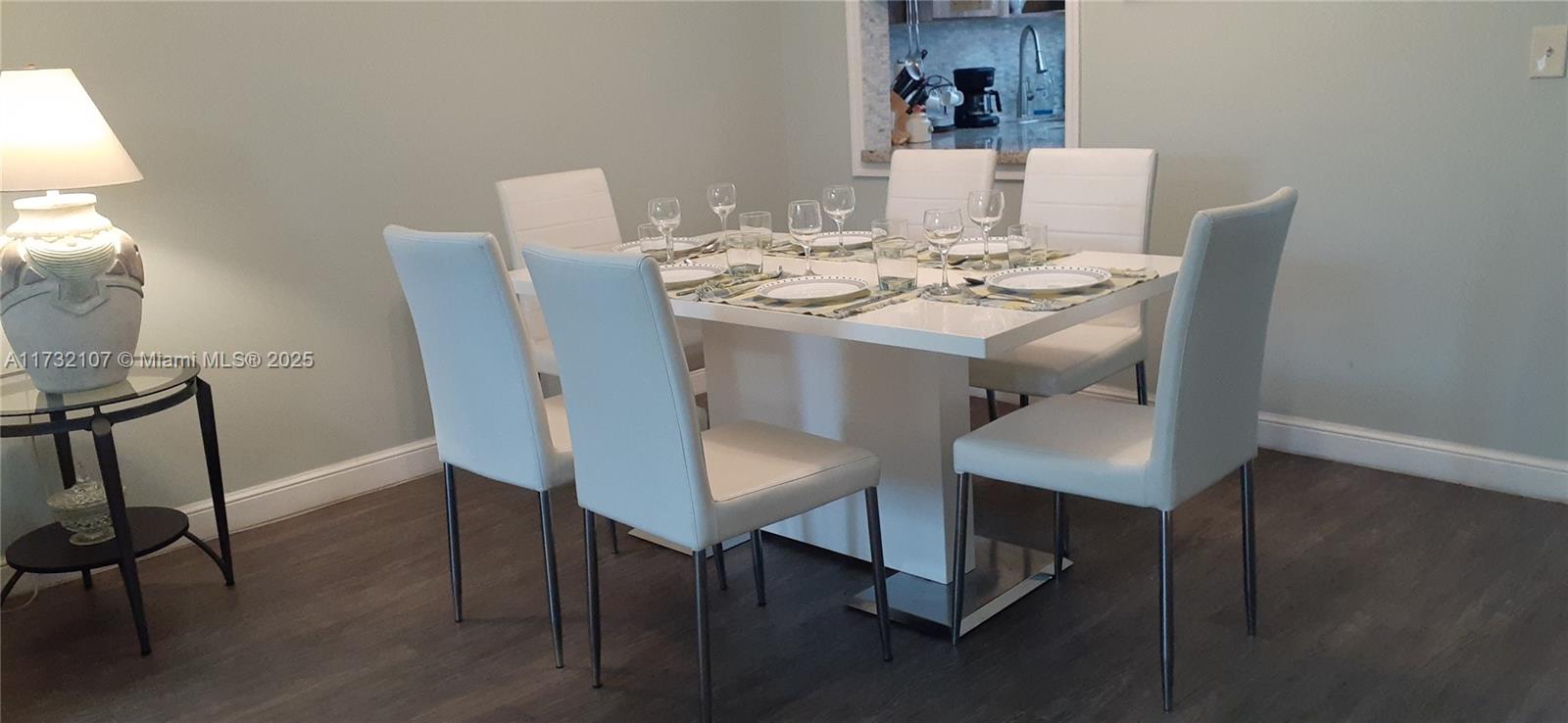 250 Gate Road, Unit 160 Hollywood, FL 33024 - Photo 4 of 33 a view of a dining room with furniture and wooden floor