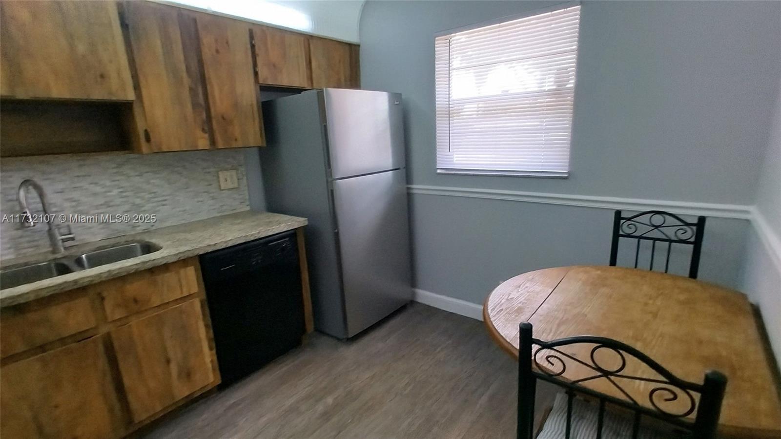 250 Gate Road, Unit 160 Hollywood, FL 33024 - Photo 8 of 33 a kitchen with stainless steel appliances a refrigerator a sink a stove a table and chairs