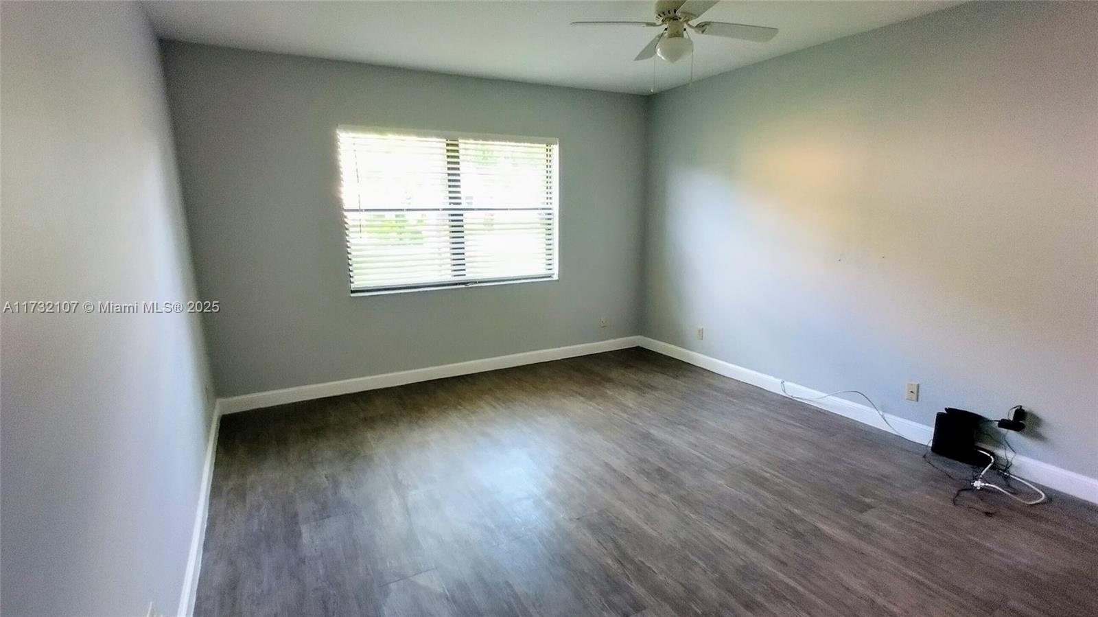 250 Gate Road, Unit 160 Hollywood, FL 33024 - Photo 9 of 33 an empty room with wooden floor and windows