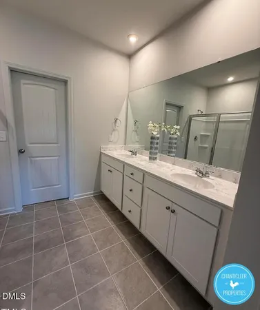 a bathroom with a double vanity sink a mirror and a