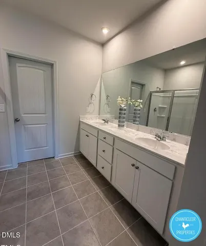 a bathroom with a double vanity sink a mirror and a