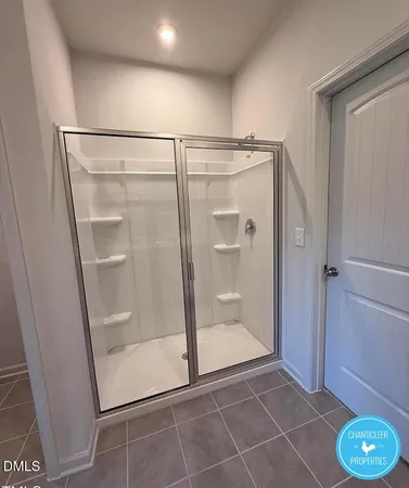 a bathroom with a glass shower door and a sink