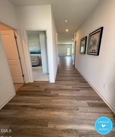 a view of a hallway view with wooden floor and a large window