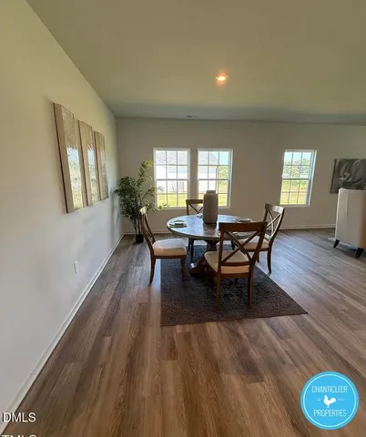 a dining room with furniture and wooden floor