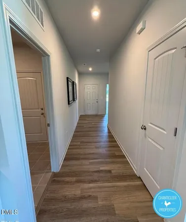a view of a hallway with wooden floor
