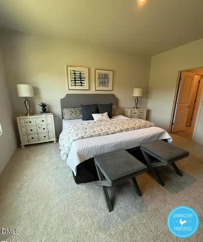 a bed room with a bed and a chair
