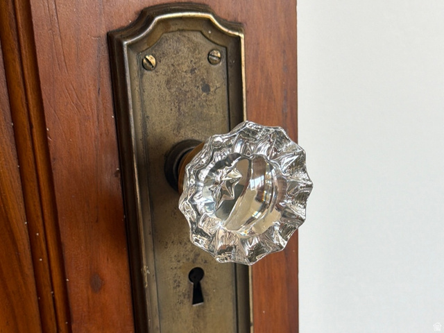 4883 South Center Street Murray, UT 84107 - Photo 17 of 32 Wood-panel door featuring a faceted crystal doorknob with an aged brass backplate and exposed keyhole